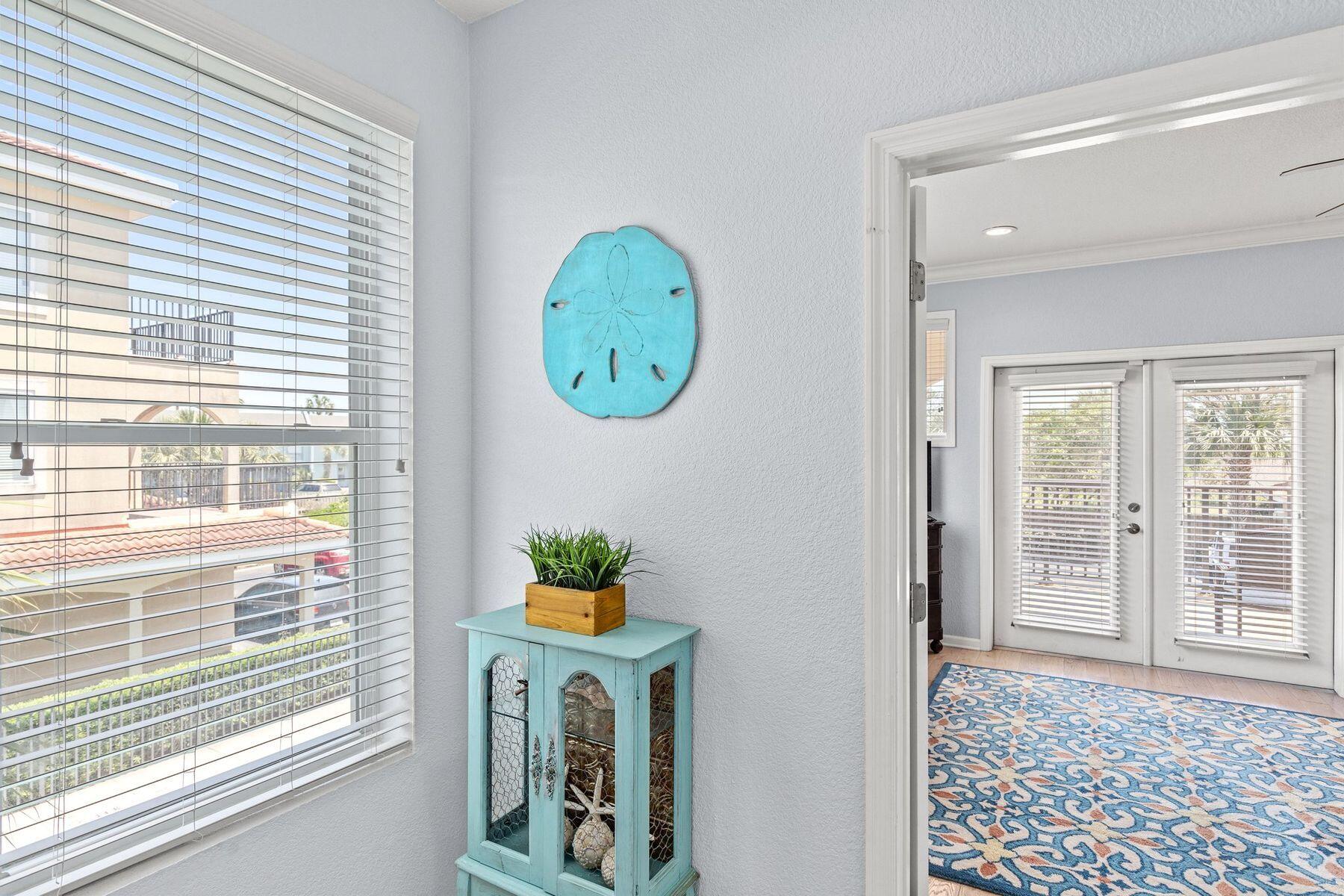 156 Southfields Road Panama City Beach, FL 32413 - Photo 25 of 35 a view of a hallway with entryway and wooden floor