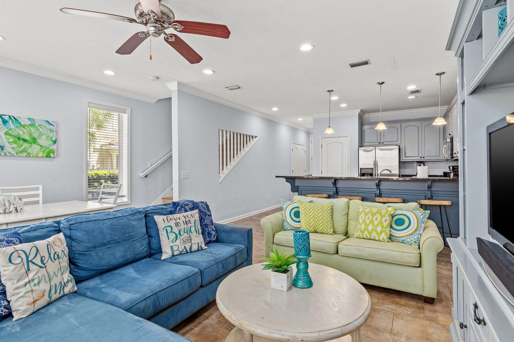 156 Southfields Road Panama City Beach, FL 32413 - Photo 3 of 35 a living room with furniture and a dining table with wooden floor