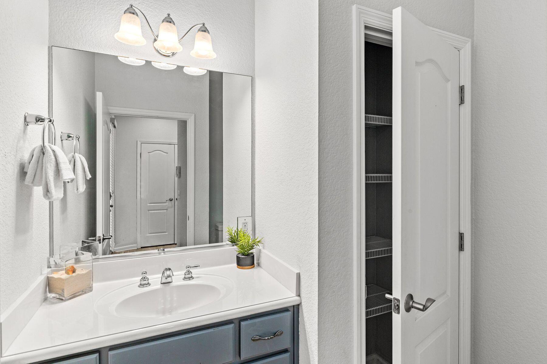 156 Southfields Road Panama City Beach, FL 32413 - Photo 8 of 35 a bathroom with a sink vanity and a mirror