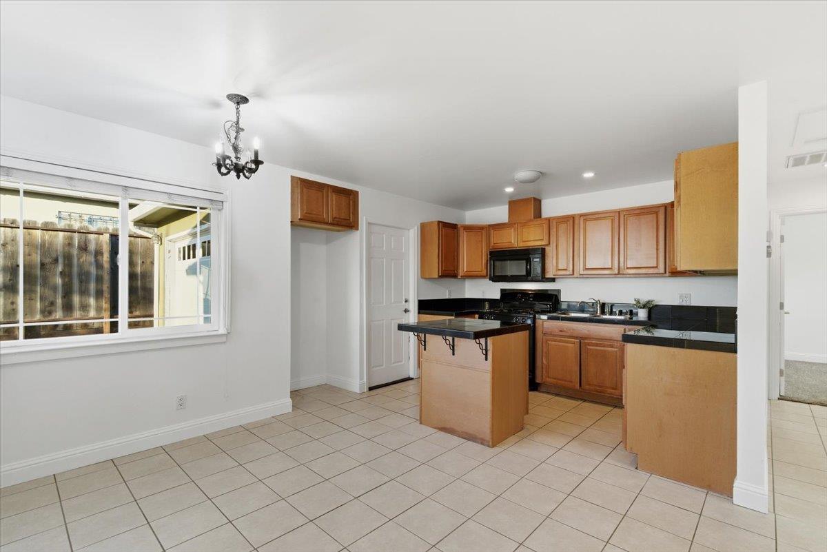 1610 Soto Street Seaside, CA 93955 - Photo 7 of 20 a kitchen with stainless steel appliances granite countertop a refrigerator and a stove top oven