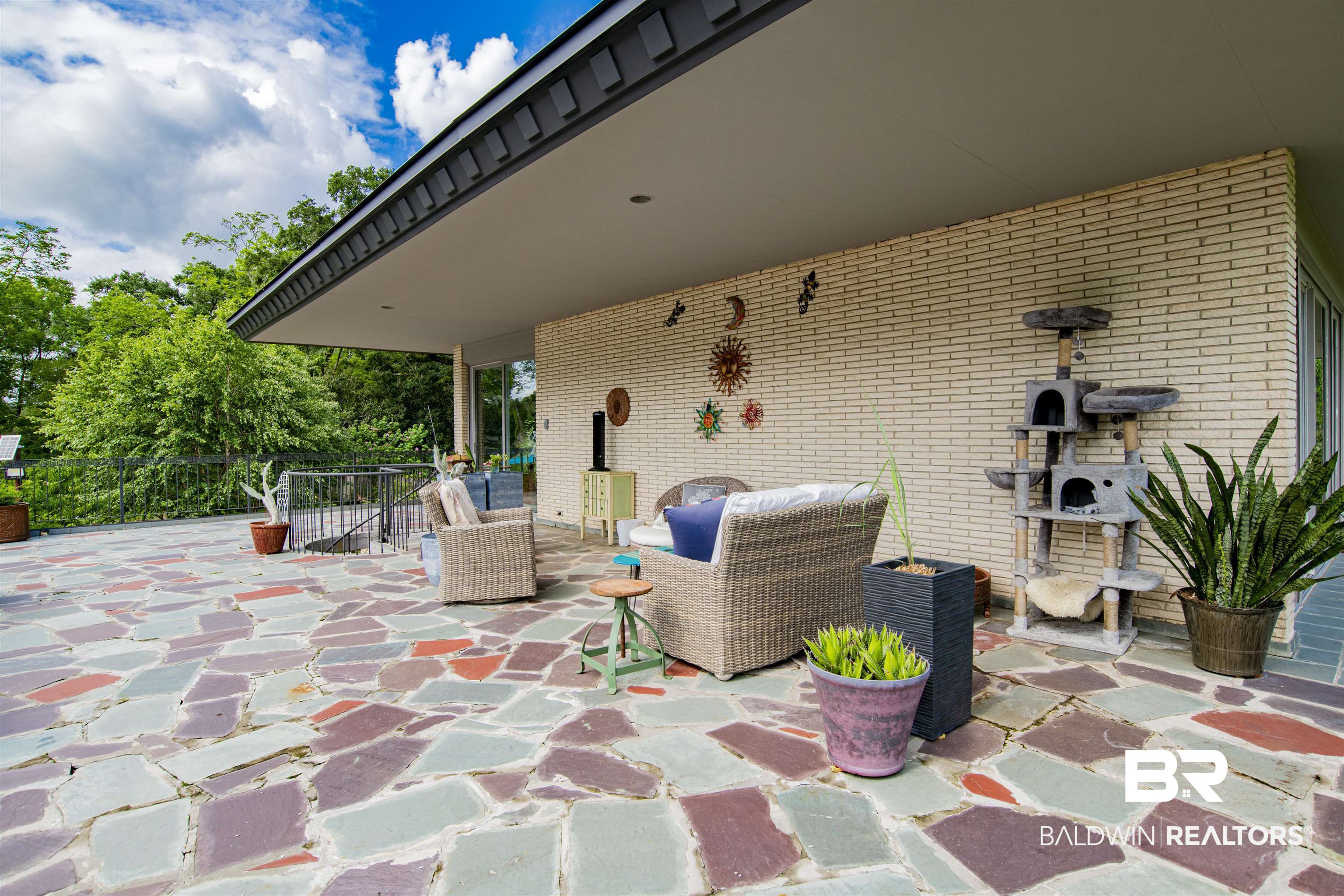 809 Bernard Circle Mobile, AL 36693 - Photo 9 of 75 Expansive flagstone patio with a partial overhang and exterior brick wall