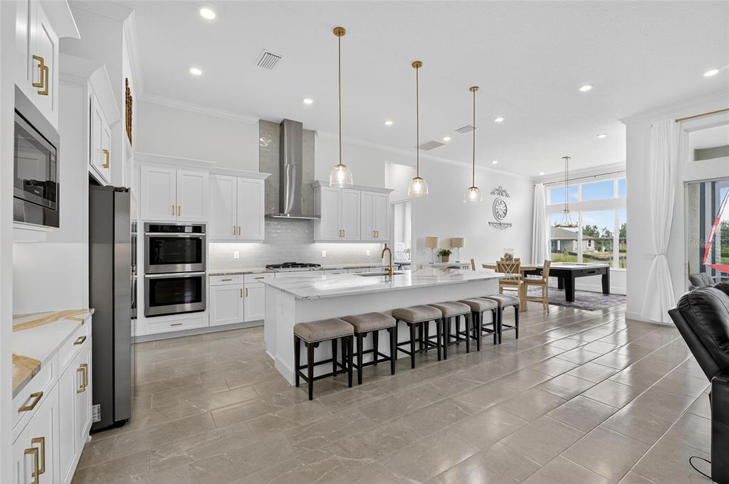 5975 Blakeney Loop Apollo Beach, FL 33572 - Photo 15 of 100 a large kitchen with a table and chairs