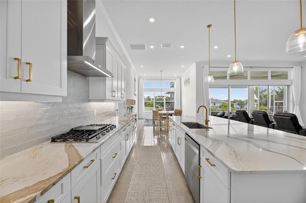 5975 Blakeney Loop Apollo Beach, FL 33572 - Photo 23 of 100 a kitchen with stainless steel appliances granite countertop a sink and cabinets