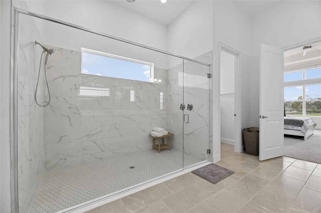 5975 Blakeney Loop Apollo Beach, FL 33572 - Photo 28 of 100 a bathroom with a shower and a toilet