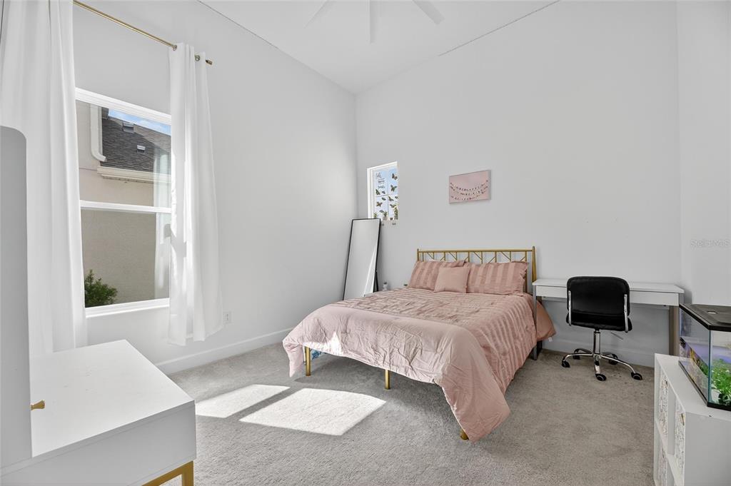 5975 Blakeney Loop Apollo Beach, FL 33572 - Photo 35 of 100 a bedroom with a bed and a desk