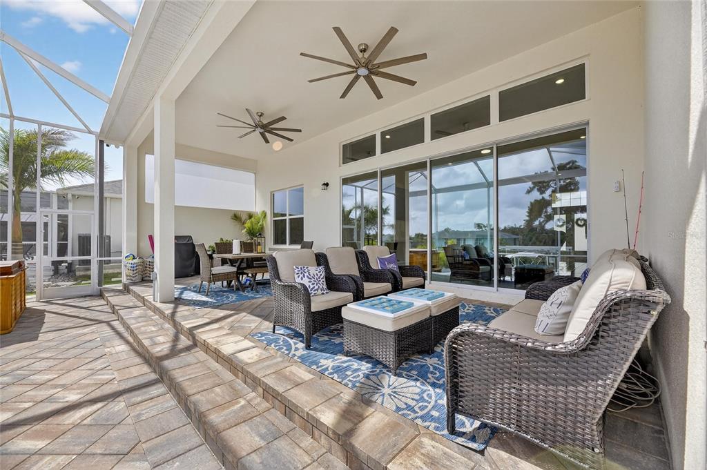 5975 Blakeney Loop Apollo Beach, FL 33572 - Photo 55 of 100 a living room with patio furniture and a large window