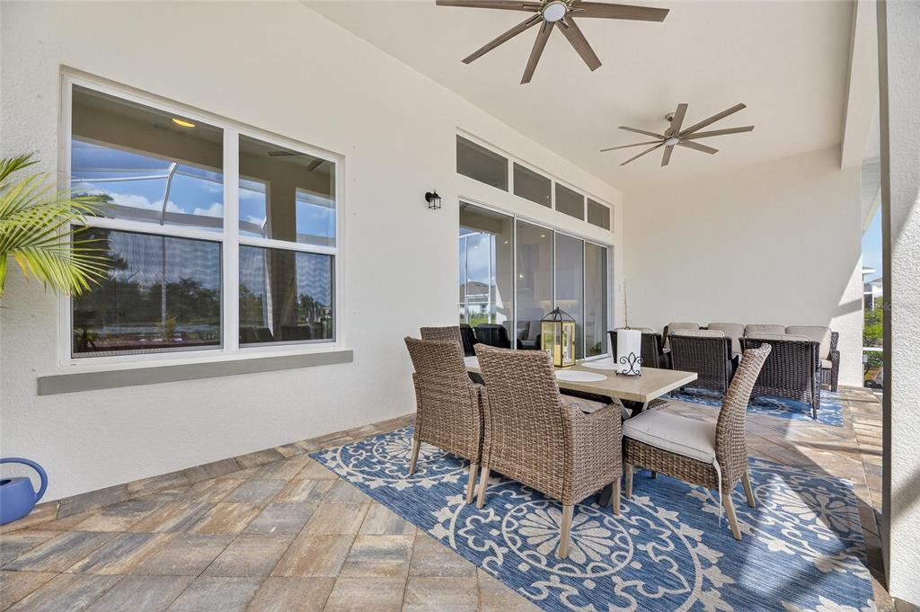 5975 Blakeney Loop Apollo Beach, FL 33572 - Photo 55 of 100 a dining room with furniture a chandelier and wooden floor