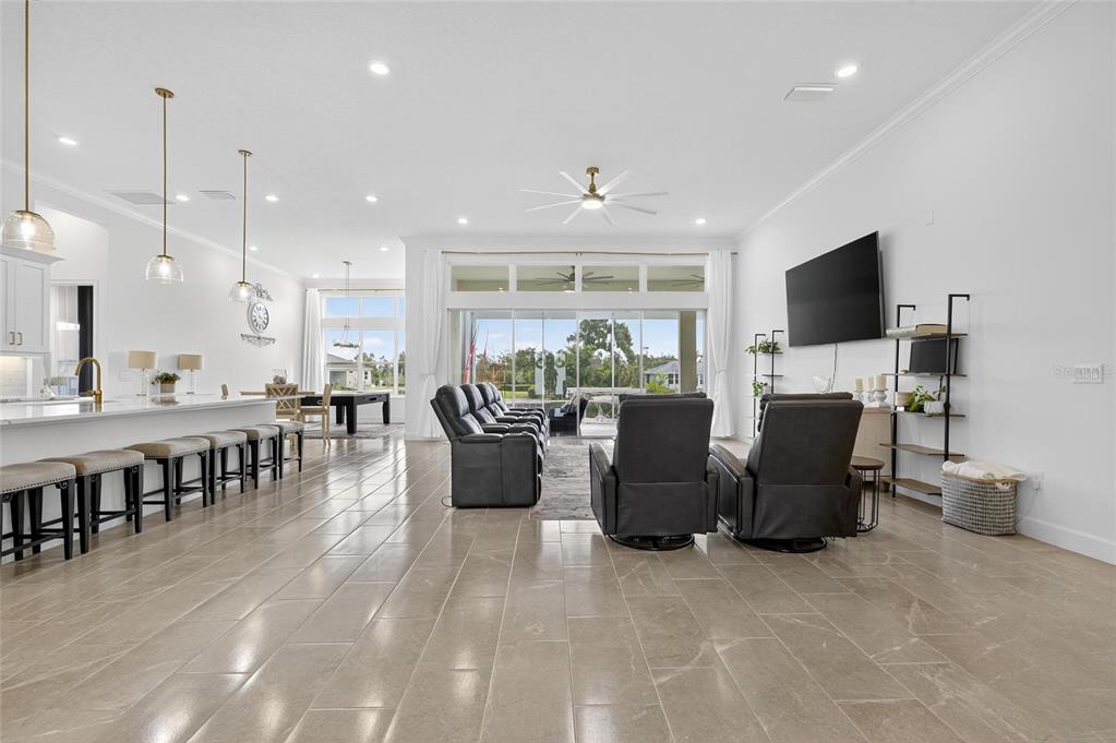 5975 Blakeney Loop Apollo Beach, FL 33572 - Photo 8 of 100 a living room with furniture a fireplace and a flat screen tv