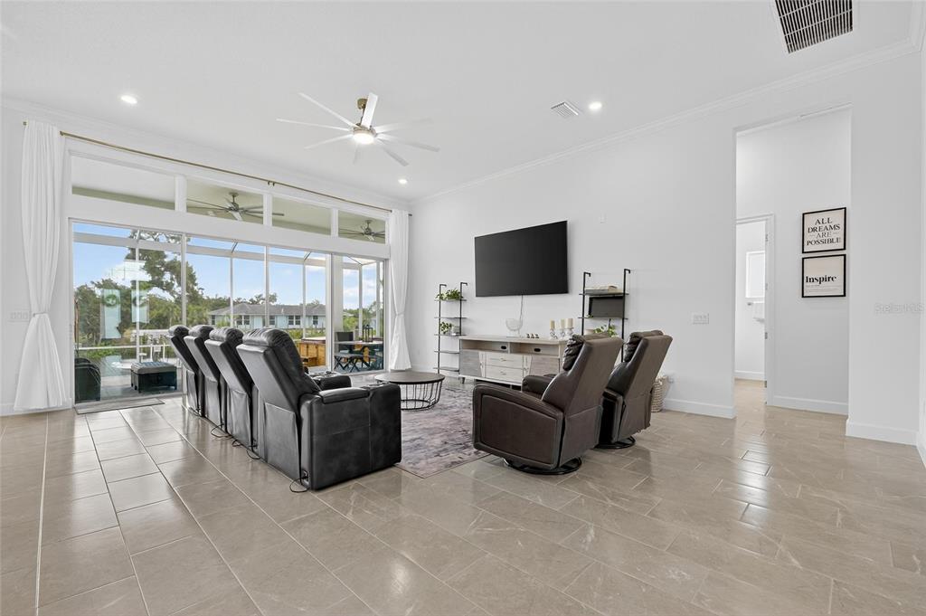5975 Blakeney Loop Apollo Beach, FL 33572 - Photo 10 of 100 a living room with furniture and a flat screen tv