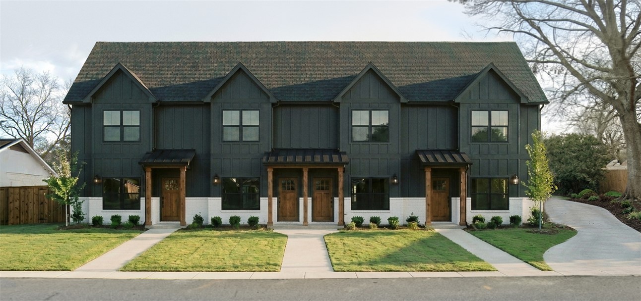 This modern townhome features a unique facade and inviting walkways, offering a blend of style and convenience.