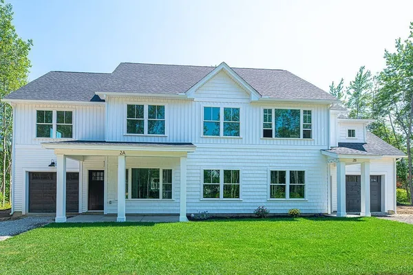 a front view of a house with a yard