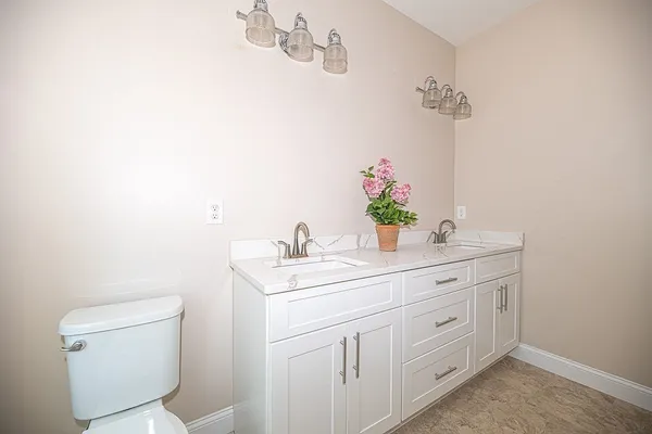 a bathroom with a toilet sink and mirror