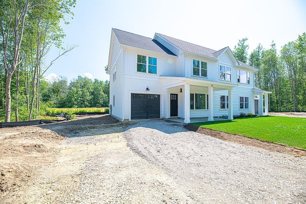 16 Meadowview Lane, Unit B Salisbury, MA 01952 - Photo 2 of 23 a front view of a house with a yard and trees