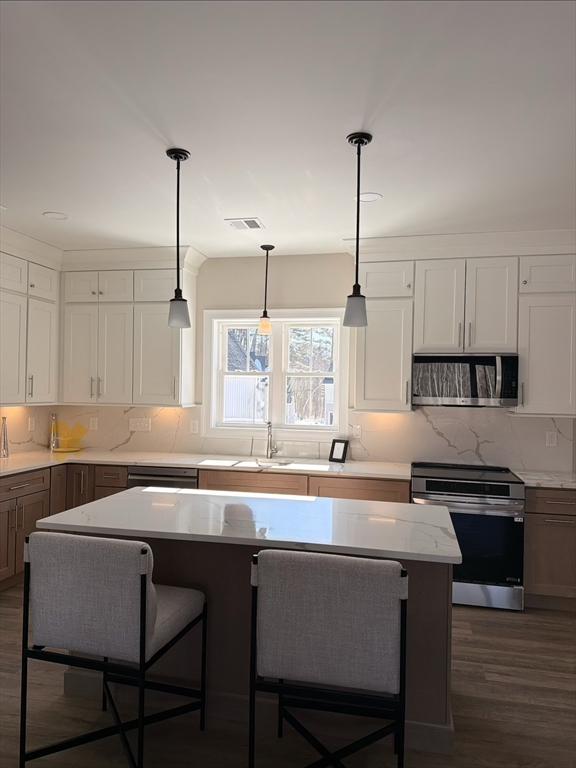 16 Meadowview Lane, Unit B Salisbury, MA 01952 - Photo 4 of 23 a kitchen with a table chairs and cabinets
