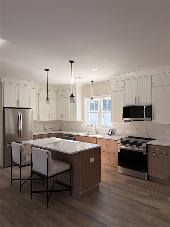 16 Meadowview Lane, Unit B Salisbury, MA 01952 - Photo 5 of 23 a kitchen with stainless steel appliances granite countertop a sink stove and refrigerator