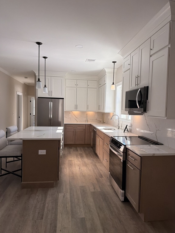 16 Meadowview Lane, Unit B Salisbury, MA 01952 - Photo 6 of 23 a kitchen with stainless steel appliances a sink a stove a refrigerator and a oven