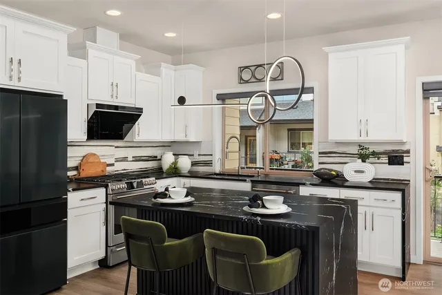a kitchen with a sink stove and refrigerator