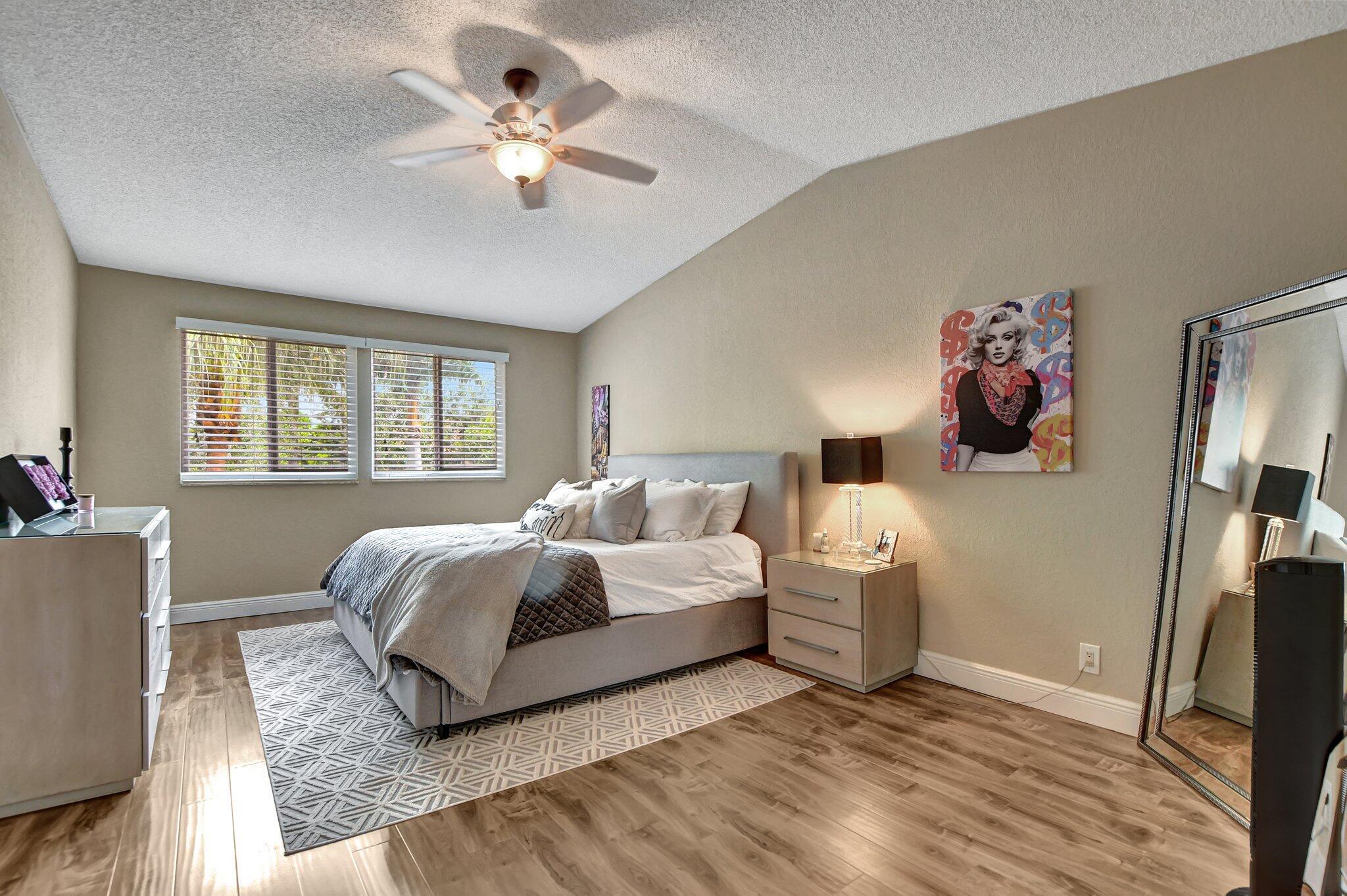 6682 Via Regina Boca Raton, FL 33433 - Photo 12 of 46 a spacious bedroom with a bed and a large window