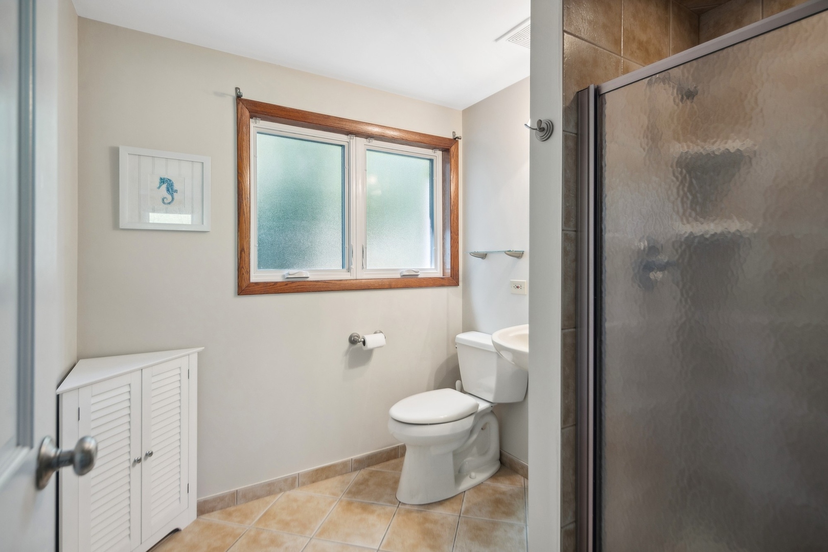 7717 Sawyer Road Darien, IL 60561 - Photo 13 of 15 a bathroom with a toilet and a shower