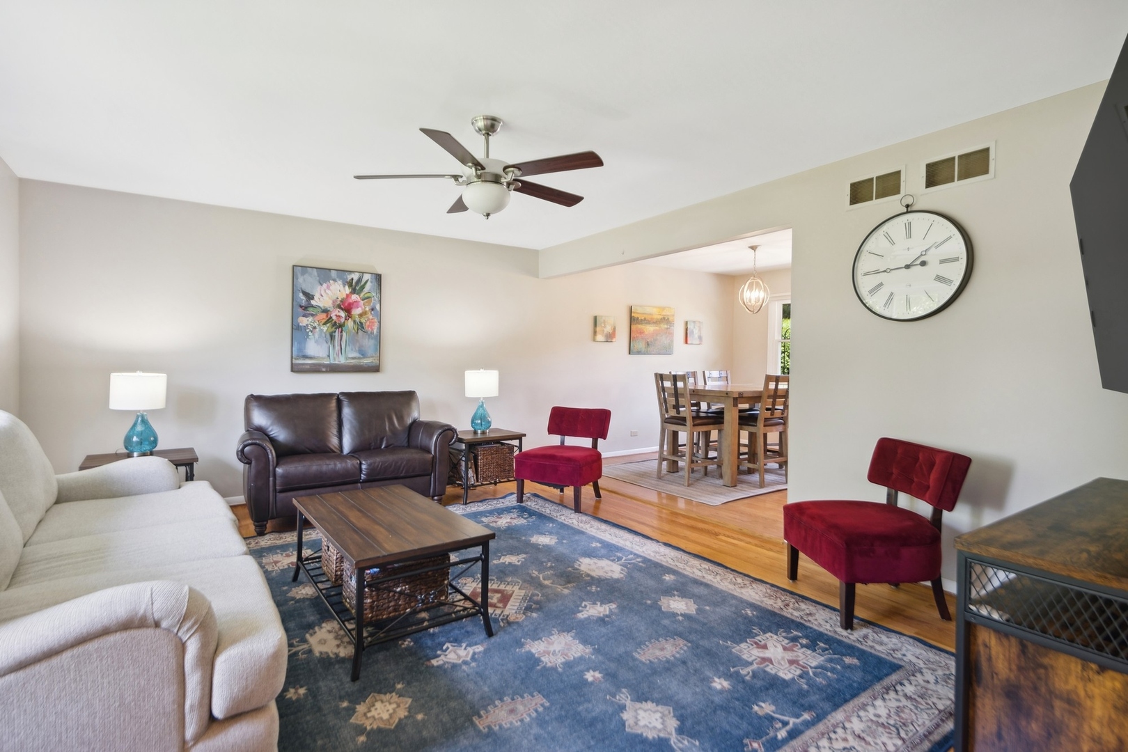 7717 Sawyer Road Darien, IL 60561 - Photo 3 of 15 a living room with furniture a rug and a wall painting