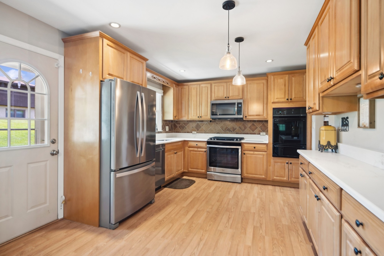 7717 Sawyer Road Darien, IL 60561 - Photo 5 of 15 a kitchen with a refrigerator a stove top oven a sink dishwasher and a refrigerator