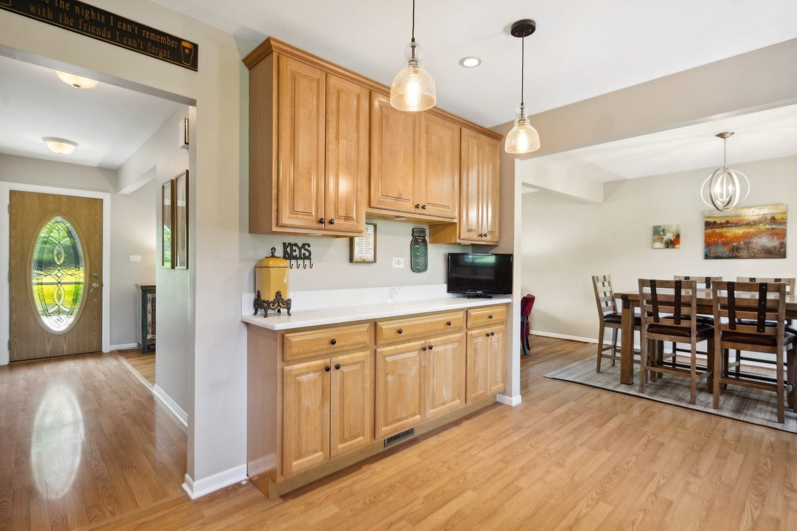 7717 Sawyer Road Darien, IL 60561 - Photo 6 of 15 a kitchen with stainless steel appliances granite countertop a sink a stove a dining table and chairs with wooden floor