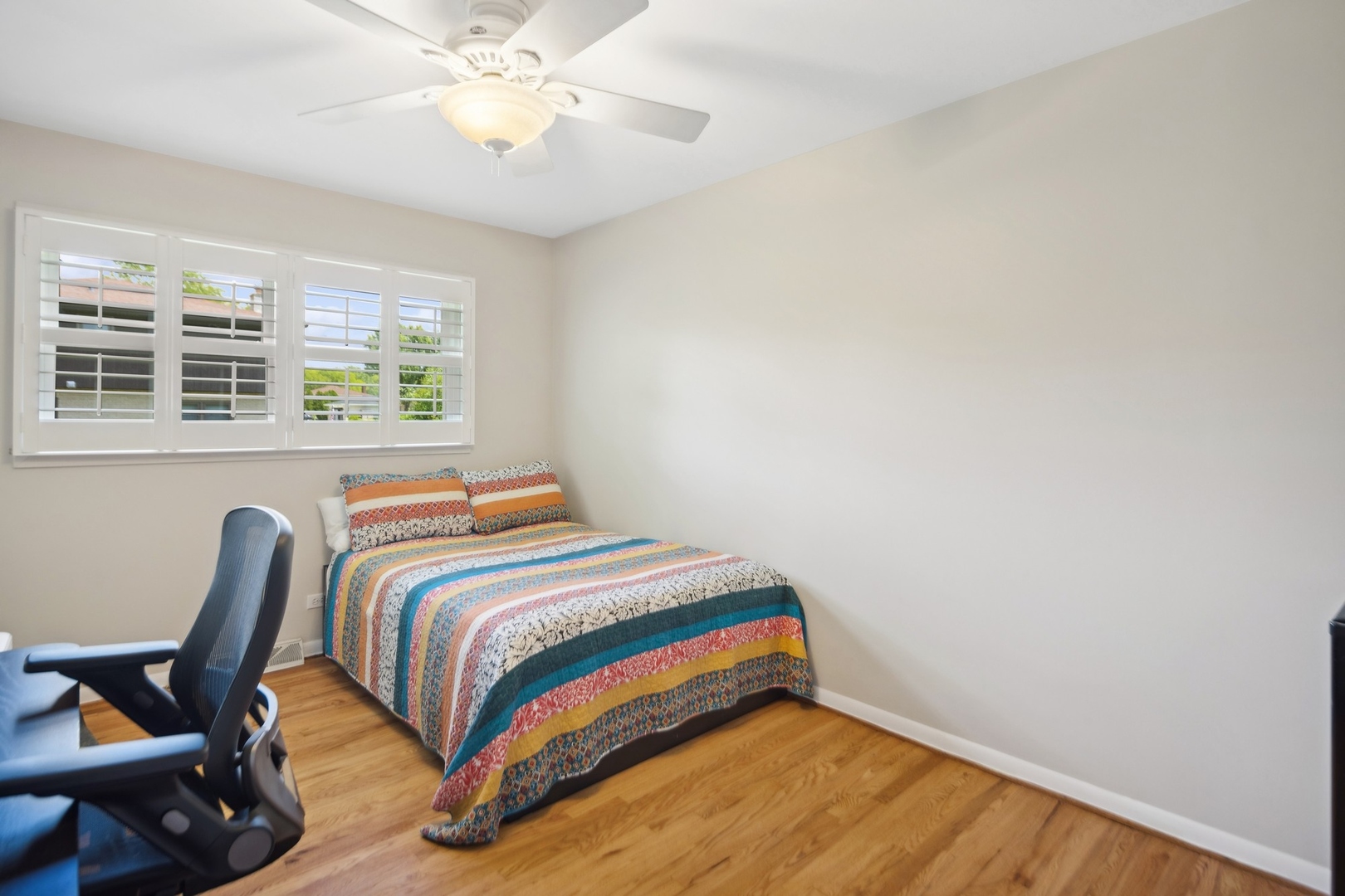7717 Sawyer Road Darien, IL 60561 - Photo 8 of 15 a bedroom with a bed and a window