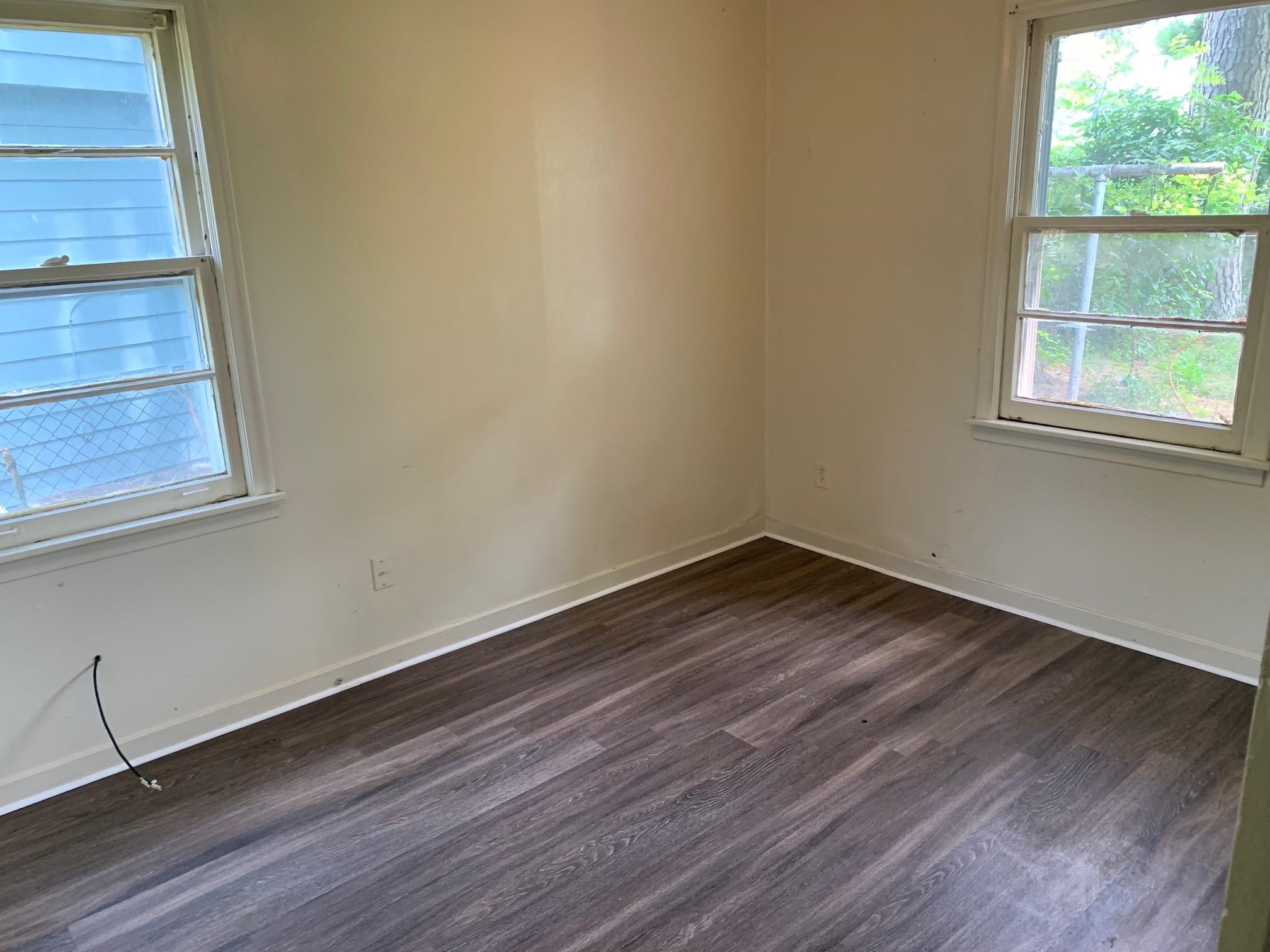 1610 Ozan Street Memphis, TN 38108 - Photo 6 of 9 wooden floor in an empty room with a window