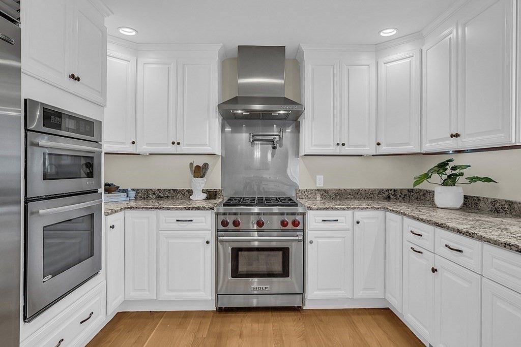 35 Pinewood Road Wellesley, MA 02482 - Photo 11 of 39 a kitchen with granite countertop white cabinets and stainless steel appliances