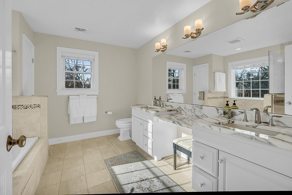 35 Pinewood Road Wellesley, MA 02482 - Photo 25 of 39 a spacious bathroom with a double vanity sink a mirror and a bathtub