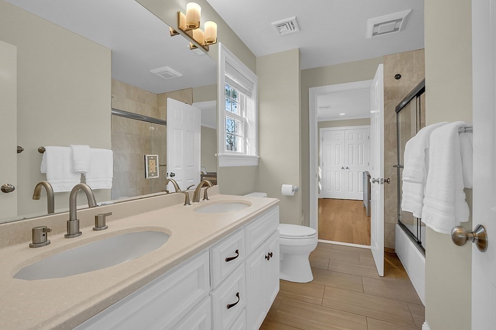 35 Pinewood Road Wellesley, MA 02482 - Photo 28 of 39 a bathroom with double vanity sink and mirror