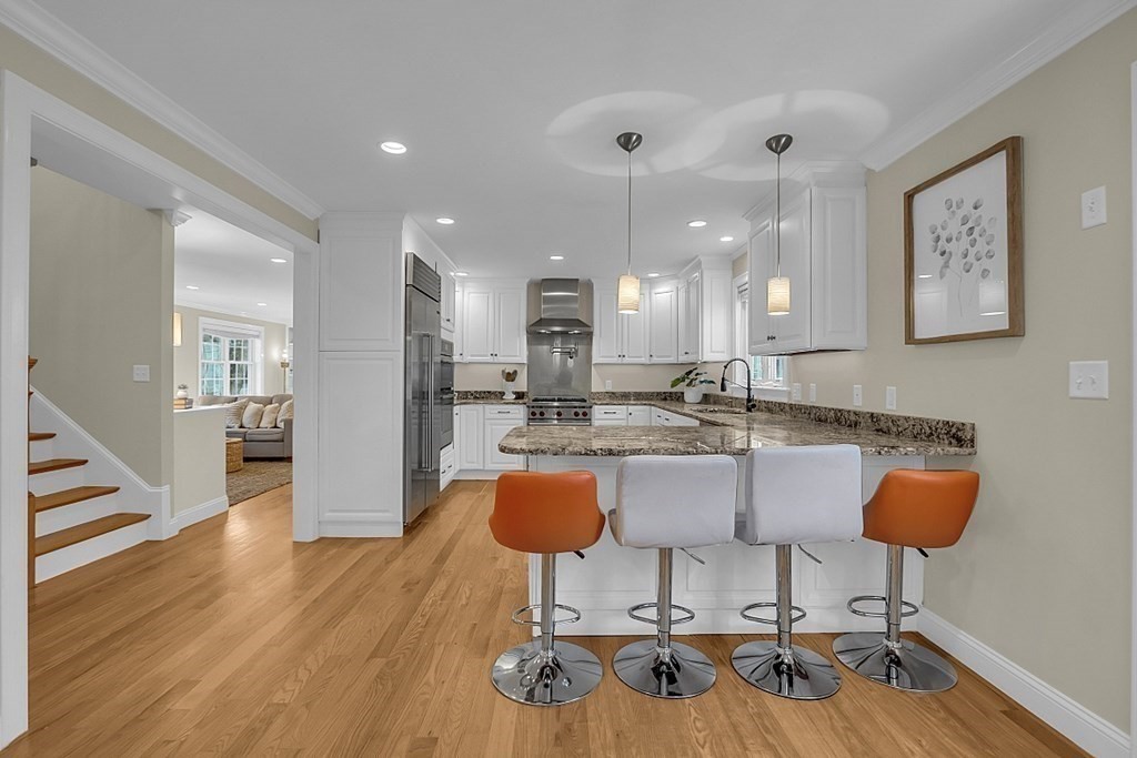 35 Pinewood Road Wellesley, MA 02482 - Photo 8 of 39 a kitchen with stainless steel appliances granite countertop a stove a sink a dining table and chairs