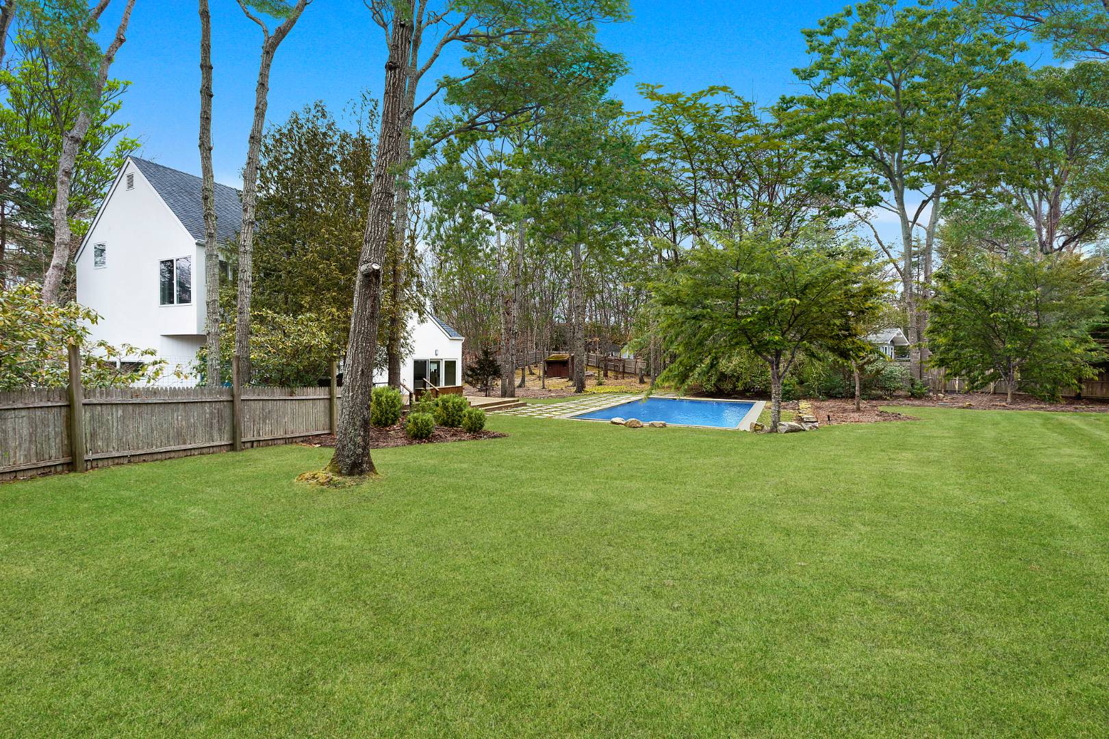 4 Fox Glove Road East Hampton, NY 11937 - Photo 15 of 15 a view of a house with a backyard