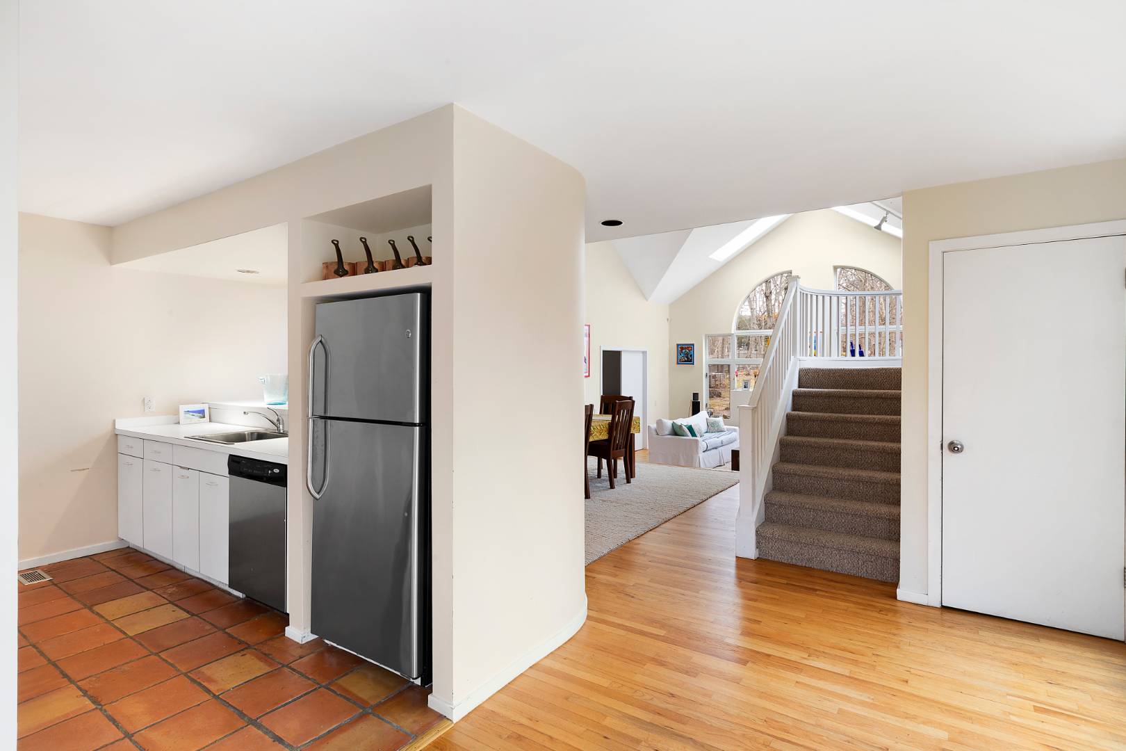 4 Fox Glove Road East Hampton, NY 11937 - Photo 3 of 15 a view of a kitchen with wooden floor electronic appliances and stairs