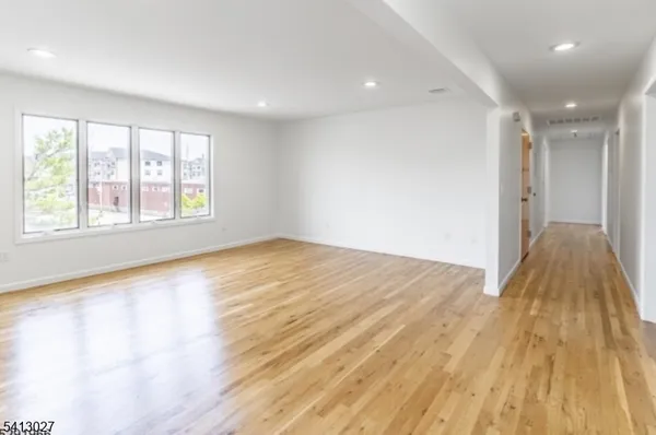 a view of a livingroom with wooden floor and a window