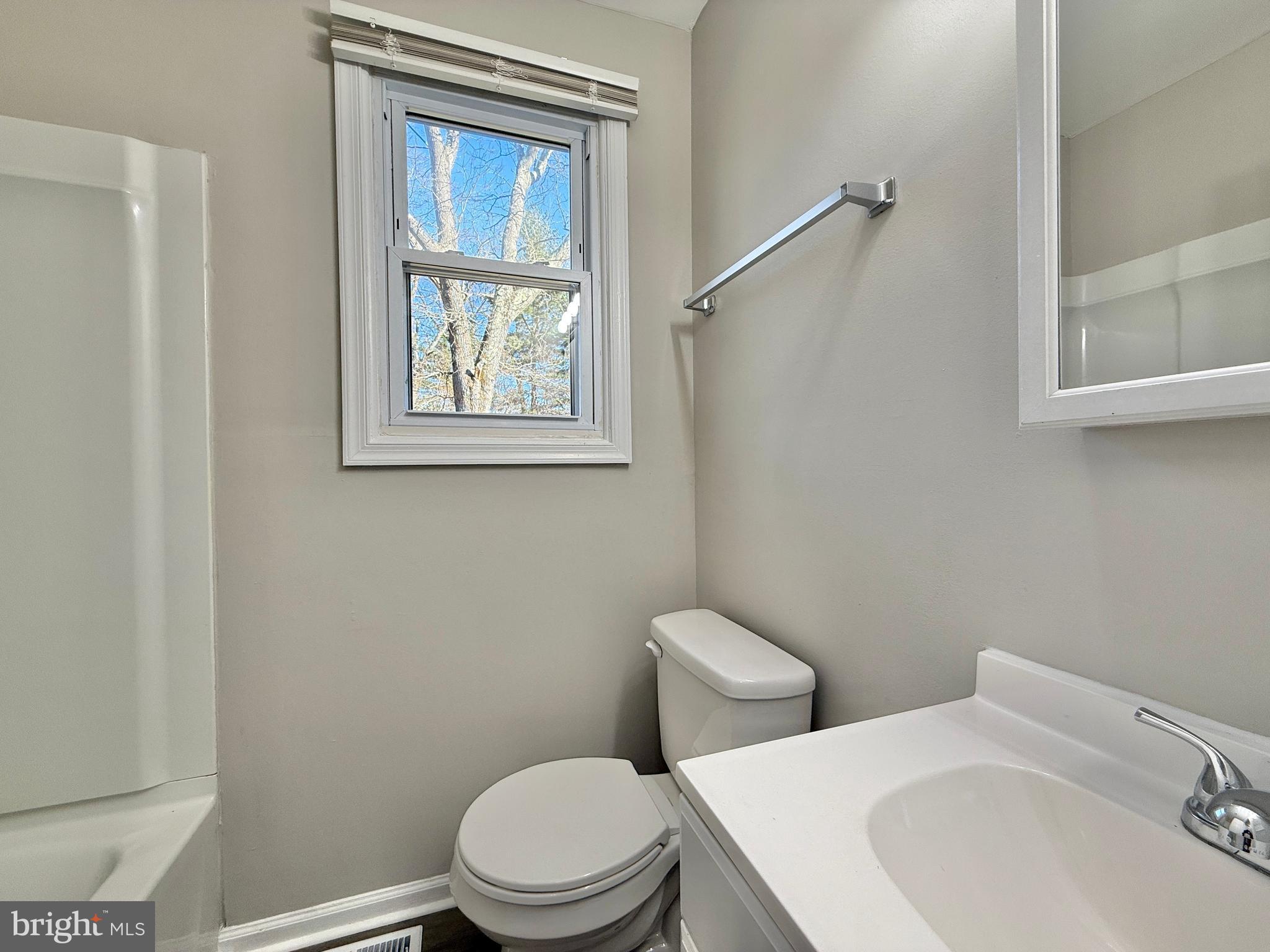 118 Colin Road Williamstown, NJ 08094 - Photo 15 of 16 a white toilet sitting next to a bathroom sink