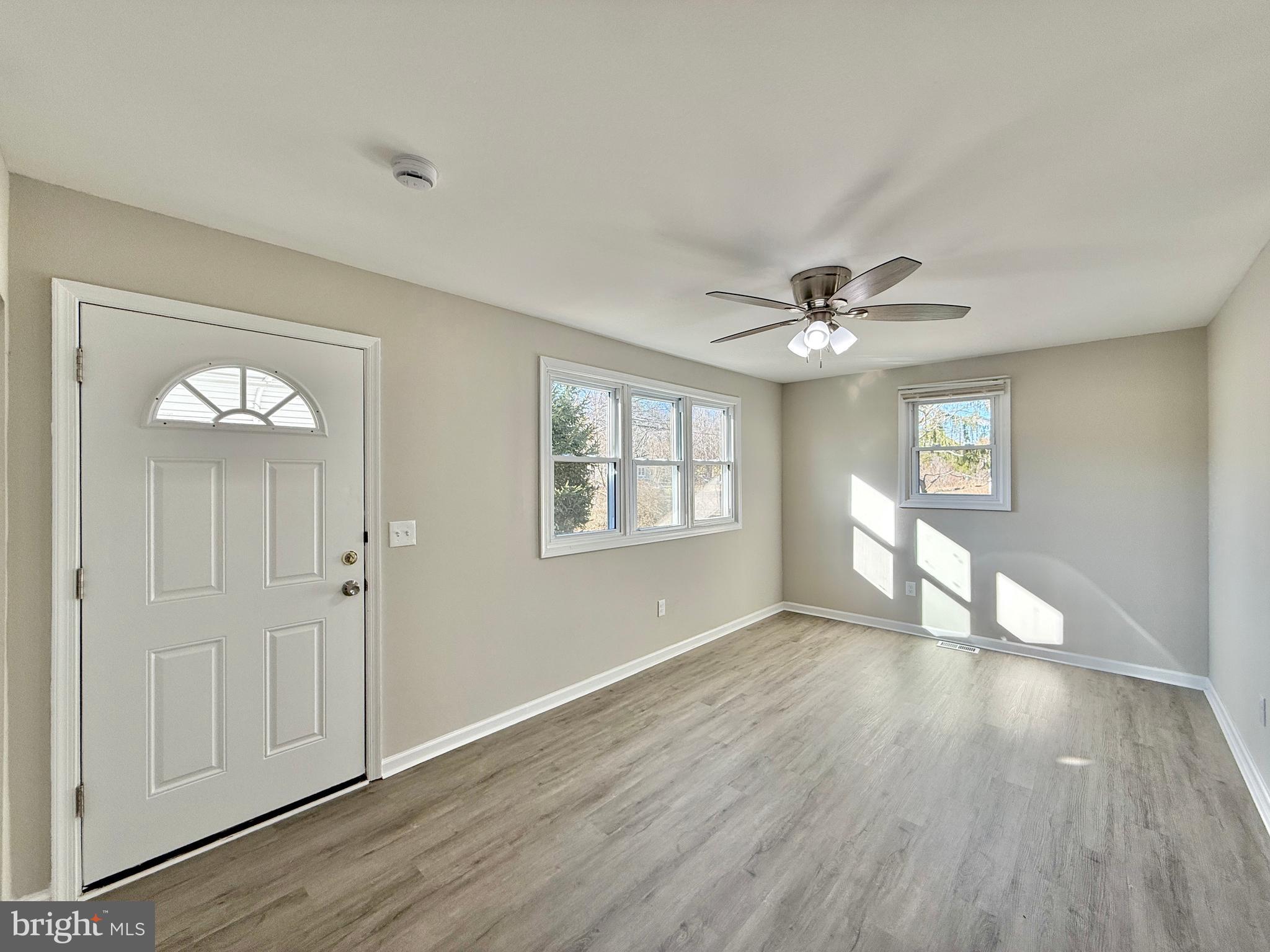 118 Colin Road Williamstown, NJ 08094 - Photo 7 of 16 a view of an empty room with wooden floor and a window