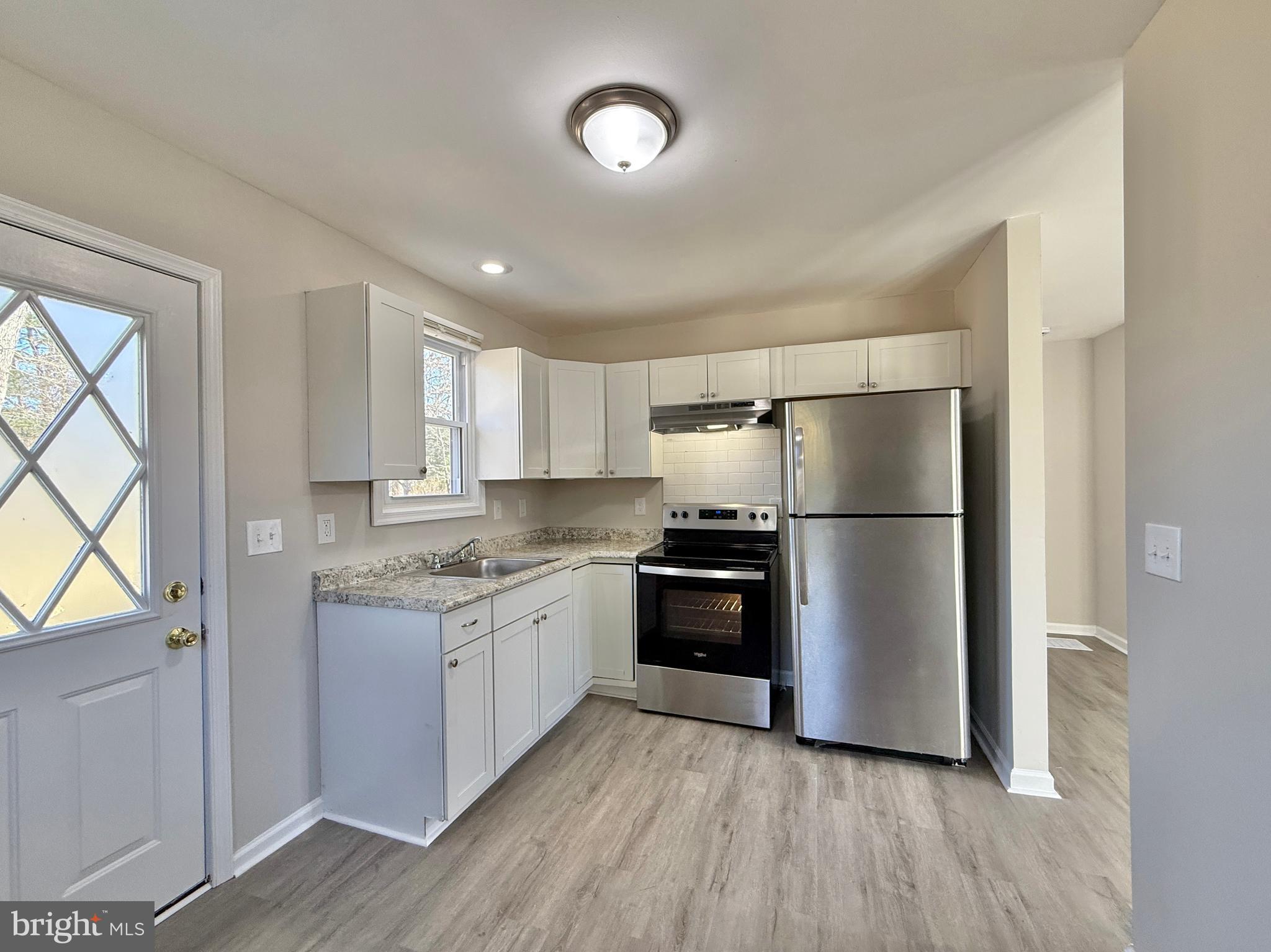 118 Colin Road Williamstown, NJ 08094 - Photo 10 of 16 a kitchen with stainless steel appliances granite countertop a refrigerator a stove a sink and a microwave