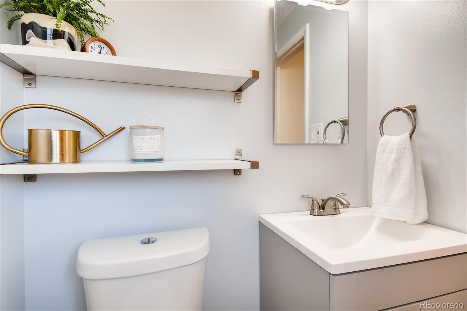 1377 South Oneida Street Denver, CO 80224 - Photo 12 of 27 a bathroom with a sink and a toilet