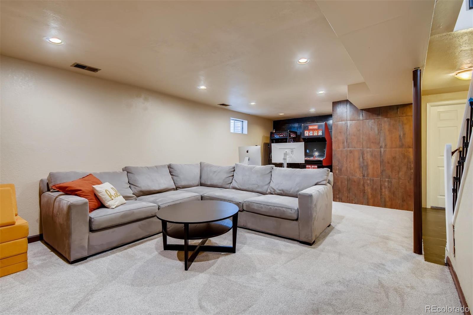 1377 South Oneida Street Denver, CO 80224 - Photo 17 of 27 a living room with furniture and a glass door