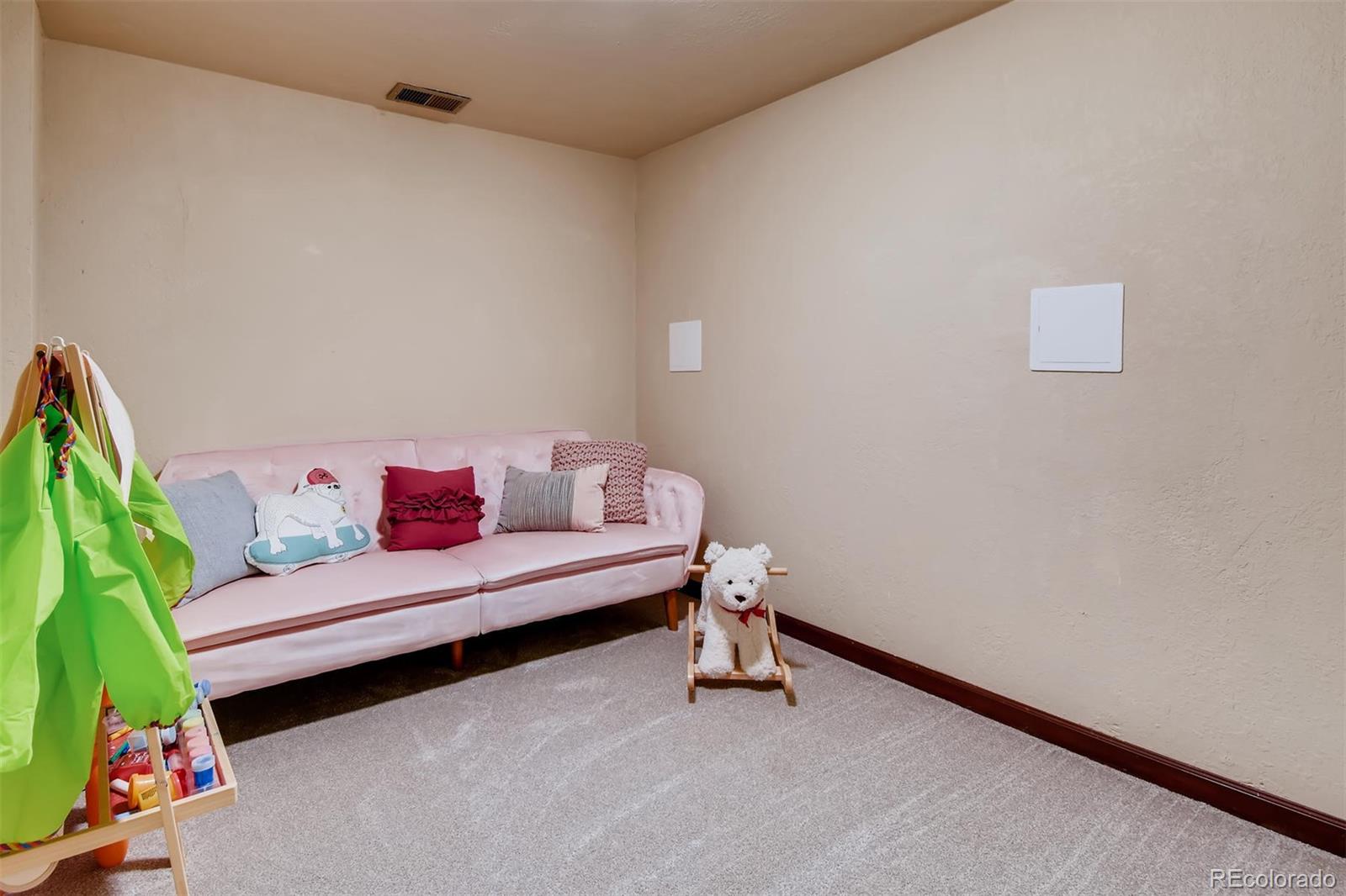 1377 South Oneida Street Denver, CO 80224 - Photo 20 of 27 a living room with furniture and a couch