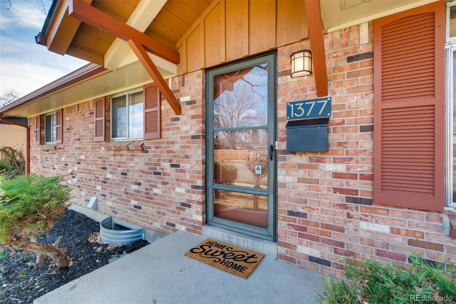 1377 South Oneida Street Denver, CO 80224 - Photo 2 of 27 a brick building with a sign on the side of it