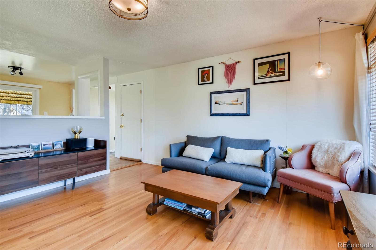1377 South Oneida Street Denver, CO 80224 - Photo 3 of 27 a living room with furniture and a wooden floor