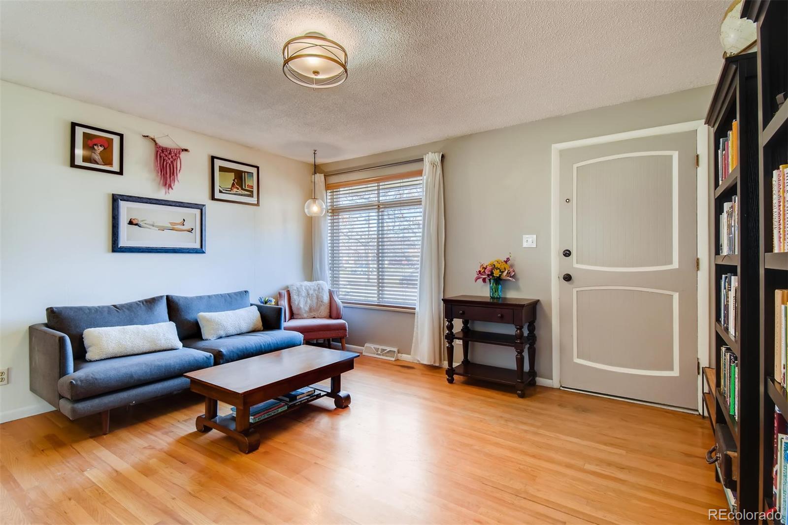 1377 South Oneida Street Denver, CO 80224 - Photo 4 of 27 a living room with furniture and a wooden floor
