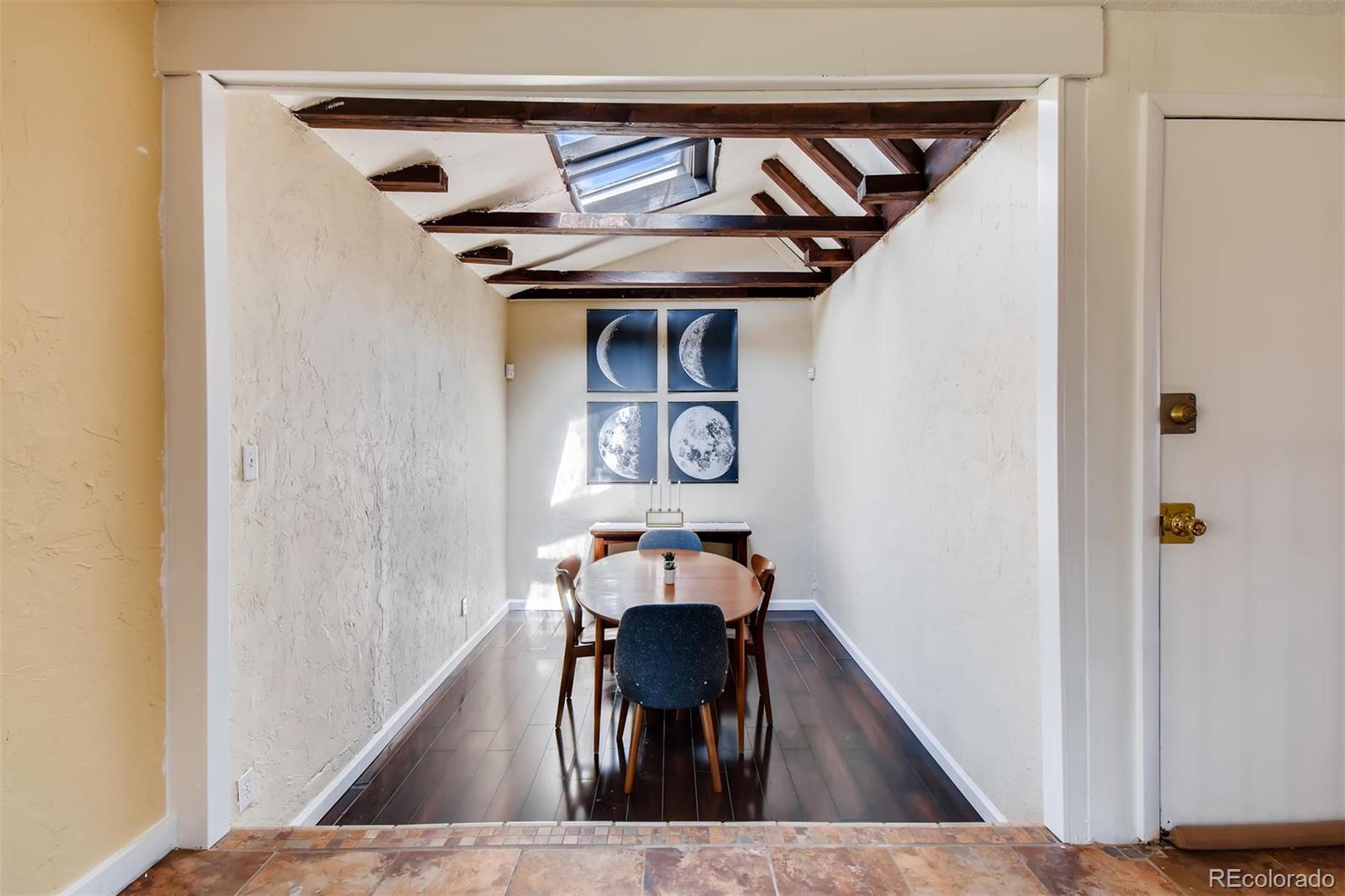 1377 South Oneida Street Denver, CO 80224 - Photo 7 of 27 a view of a hallway with wooden floor table and chairs