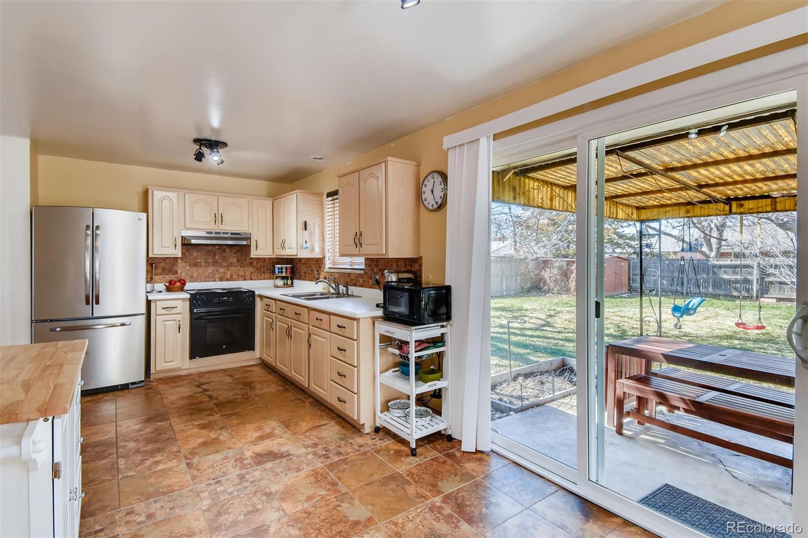 1377 South Oneida Street Denver, CO 80224 - Photo 10 of 27 a kitchen with stove cabinets and refrigerator