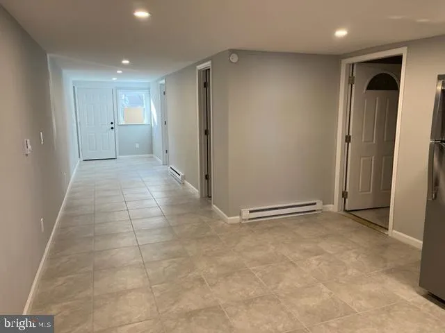 an empty room with closet and windows
