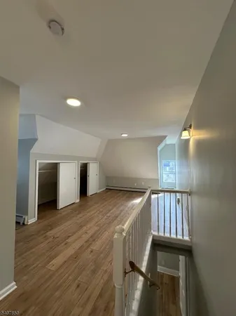 a view of an empty room and wooden floor