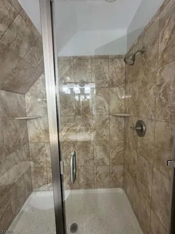 a bathroom with a glass shower door