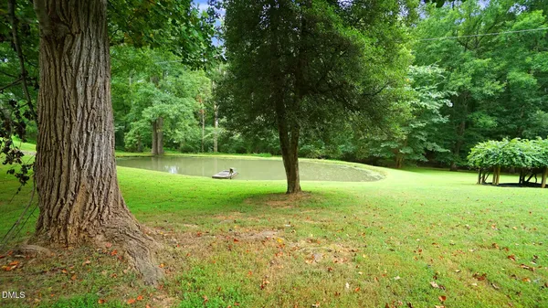 an aerial view of a house with a yard basket ball court and outdoor seating
